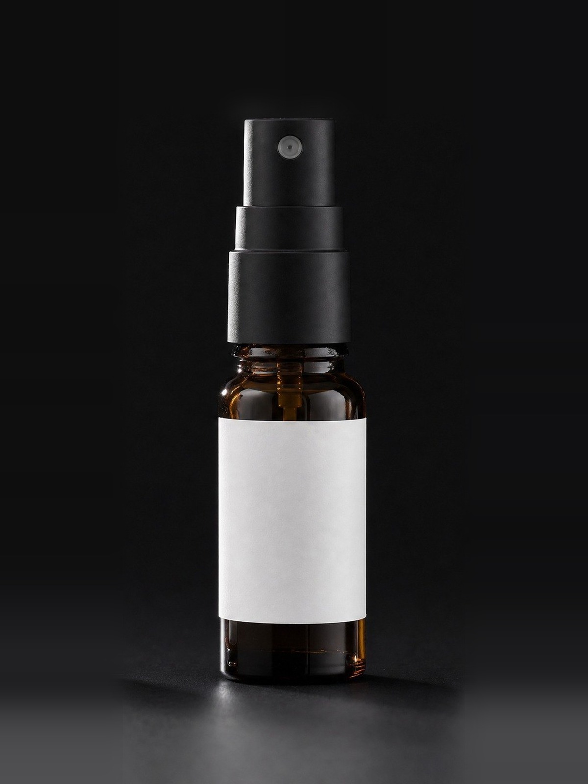 Atomizador de laboratorio · 5 ml sobre fondo de estudio negro, con la etiqueta sin rotular